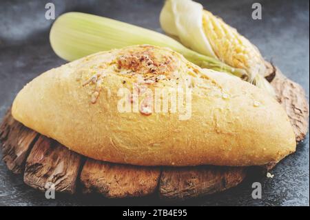 Fresh cornbread and corn grains on the table. Food grain crisis concept. Top view. Close up Stock Photo