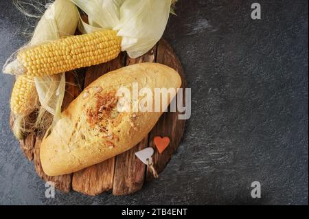 Fresh cornbread and corn grains on the table. Food grain crisis concept. Top view. Copy space Stock Photo