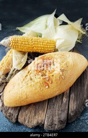 Fresh cornbread and corn grains on the table. Food grain crisis concept. Top view. Copy space. Stock Photo