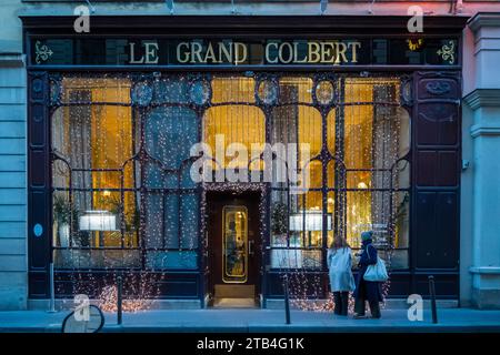 Paris, France, Tourists looking at Le Grand Colbert that is a famous french restaurant, Editorial only. Stock Photo