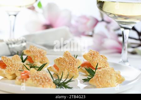 Festive appetizer of puff pastry in the shape of a star, stuffed with salmon and soft cheese. The perfect appetizer for your holiday table. Stock Photo