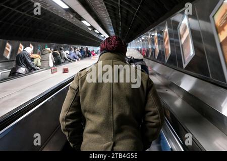 London, United Kingdom - February 02, 2019: Riding up the escalators in London tube during busy time, people on both sides Stock Photo