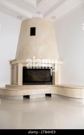 The interior of the living room with a fireplace is lined with marble. Stock Photo
