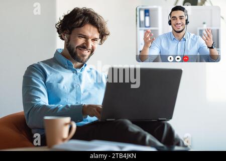 Cheerful Guy Looking At Screen Have Video Call With Colleague Stock Photo