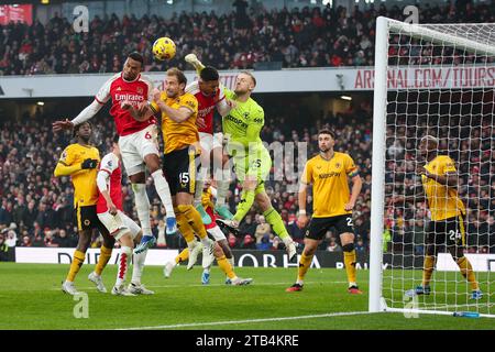 LONDON, UK - 2nd Dec 2023:  Gabriel Magalhaes of Arsenal competes for the ball with Craig Dawson and Dan Bentley of Wolverhampton Wanderers during the Stock Photo