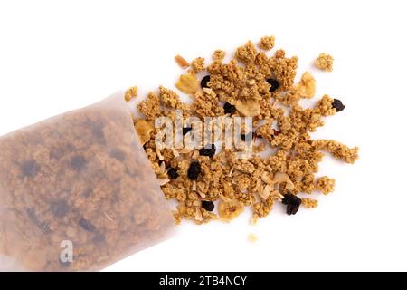 crunchy granola for breakfast, tasty granola poured out of plastic bag isolated on white background, concept healthy food Stock Photo