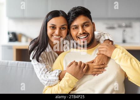 Portrait Of Happy Young Indian Couple Hugging At Home Stock Photo