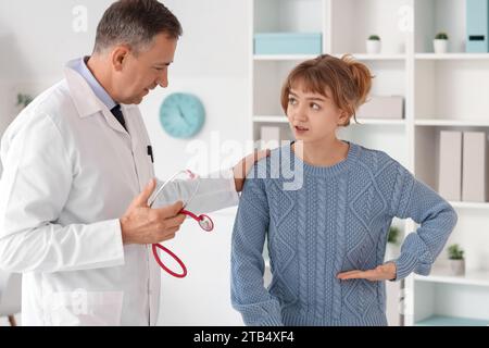 Mature doctor talking with patient in medical office Stock Photo