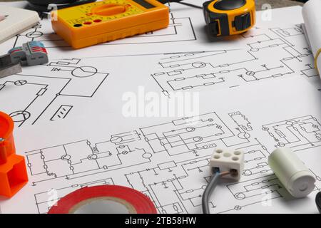 Digital multimeter and other electrician's equipment on wiring diagrams Stock Photo