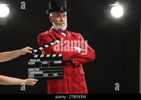 Senior actor performing role while second assistant camera holding ...