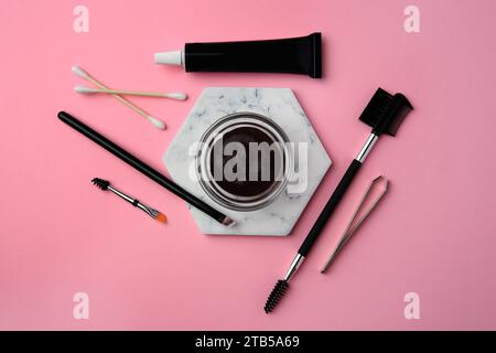 Flat lay composition with eyebrow henna and tools on pink background Stock Photo