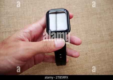 Hands holding smartwatch on wrist wearable technology Stock Photo