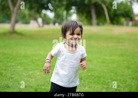 Portrait of happy cute kid playing and having fun in outdoor park. Stock Photo