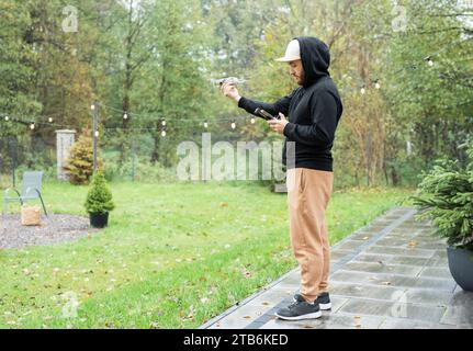 Young Man playing with drone outdoors Stock Photo