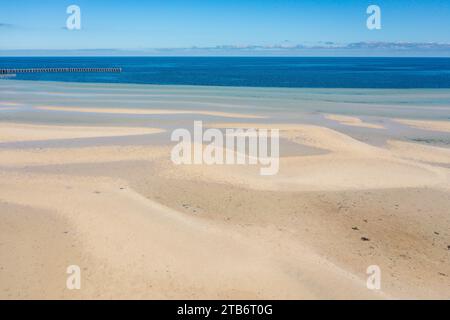 Aerial view of pools of water on a white sandy beach formed in long lines and ripples at Moonta Bay on the Yorke Peninsula in South Australia Stock Photo