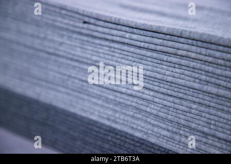 Stacked folded  Gray fabric Surface Texture Background Wallpaper. Selective Focus Stock Photo
