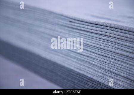 Stacked folded  Gray fabric Surface Texture Background Wallpaper. Selective Focus Stock Photo