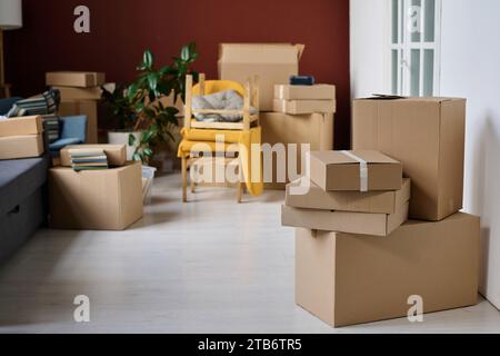 Big empty apartment with things in packed boxes during move Stock Photo