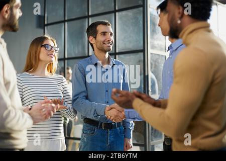 Two happy diverse professional business men executive leaders shaking hands at office meeting. Stock Photo
