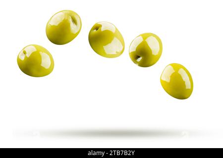 Green olives falling isolated on white background Stock Photo