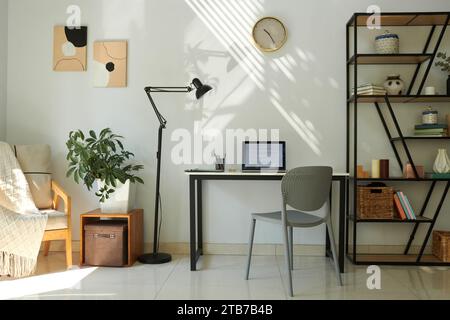 Laptop with programming code on screen on desk in home office of software developer Stock Photo