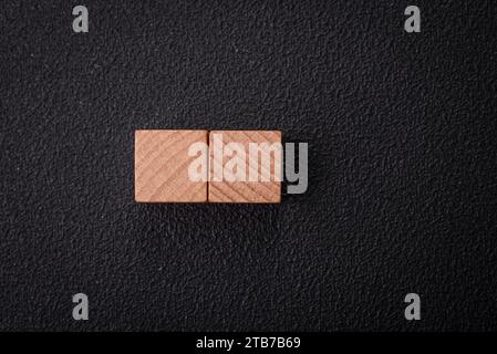 The inscription is missing or empty wooden cubes on a dark concrete background. Can be used as part of your composition Stock Photo