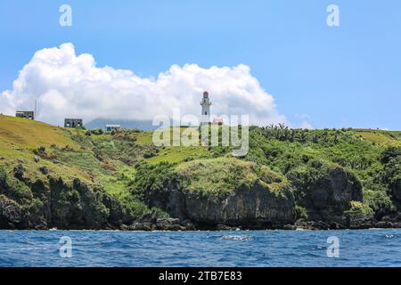 Cliffs of Batanes from the sea, view on the Basco Lighthouse on Naidi Hills, Batan island, North Philippines islands near Taiwan Stock Photo