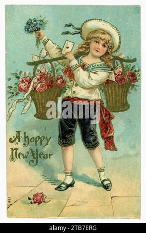 Original charming Edwardian era American New Years greetings card of young boy with long curled hair, wearing a fashionable sailor suit, breeches, with a yoke on his shoulders bearing a basket of flowers carrying a letter in one hand a a bouquet of flowers in another, dated /  posted from Brooklyn in 1907, USA. Stock Photo