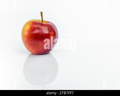 Red ripe Gala apple isolated on white background with reflection Stock Photo