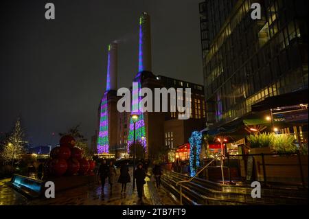 London, UK. 04th Dec, 2023. Using an ipad David Hockney has created two large green and purple striped Christmas trees, each with a gold star at the top, displayed on the power stations two 100 metre tall chimneys overlooking the River Thames. The Christmas artwork is to bring “joy and hope” to people in London, UK. Credit: Mary-Lu Bakker/Alamy Live News Credit: Mary-Lu Bakker/Alamy Live News Stock Photo