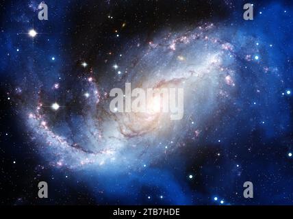 Face-on spiral galaxy with a bright luminous core, blue star-forming arms and a dense field of stars in deep space. Stock Photo