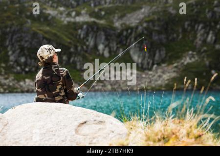 Pond of Alate in Auzat, French Pyrenees, Ariege department, Regional Nature Park of the Pyrenees Ariegeoises (south of France). Young man viewed from Stock Photo