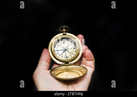 hand holding a compass for direction, isolated Stock Photo