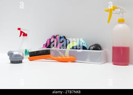 Assorted pet grooming tools and cleaning supplies on a white surface background Stock Photo