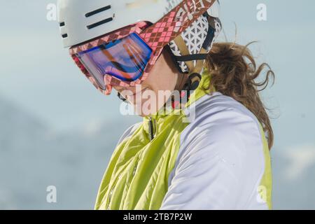 Close-up of a female skier with helmet and goggles, ready to ski in the Swiss Alps, embodying a sense of adventure and sport Stock Photo