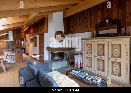 A warm and inviting chalet interior with plush seating, wooden decor ...