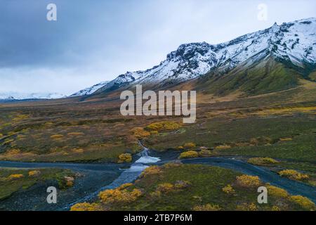 Aerial photo capturing the stunning Thorsmork valley in Iceland, with snow-capped mountains, a winding river, and autumn colors. Stock Photo