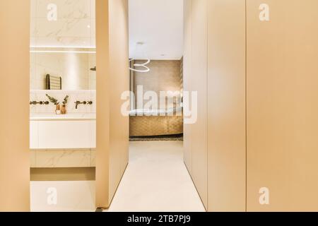 Interior of empty narrow passage leading to modern bedroom and bathroom in luxurious light apartment Stock Photo