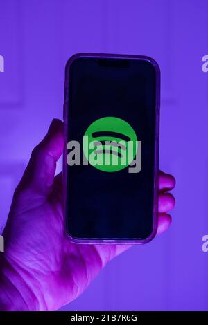 Hand holds a mobile phone on which the logo of the musi Stock Photo