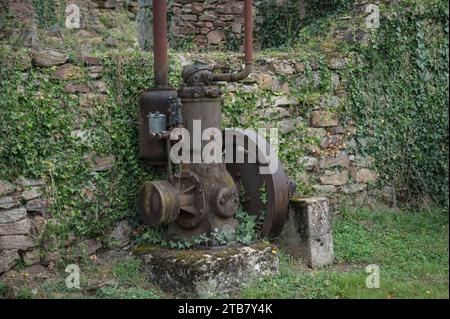 Remains of the factory machinery abandoned in the war. An ABC motor with a water camber Stock Photo
