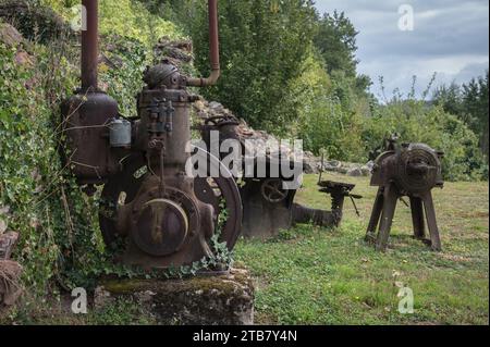 Remains of the factory machinery abandoned in the war. An ABC demilento motor with a water rope and other tools Stock Photo