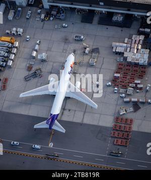 An aerial view of a Federal Express Boeing 767 airplane at Boston's Logan International Airport being loaded with cargo Stock Photo