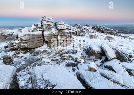 Snow and ice covered moorland at dawn on Belstone Tor in Dartmoor National Park, Devon, England.  Winter (December) 2022. Stock Photo