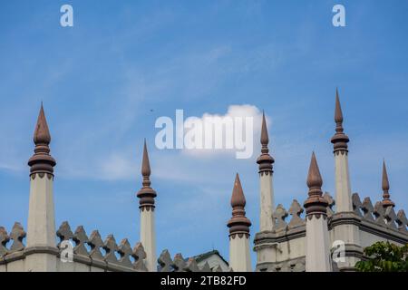 Architecture details of part of Sultan Mosque design in the sky is a fighter jet plane flying across the blue sky, Singapore Stock Photo