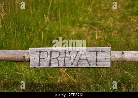 German sign saying "privat" (private) on a fence in a farm Stock Photo