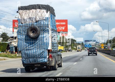 Ayutthaya, THAILAND, SEP 30 2023, A Pickup carries a tall load covered with canvas. Stock Photo