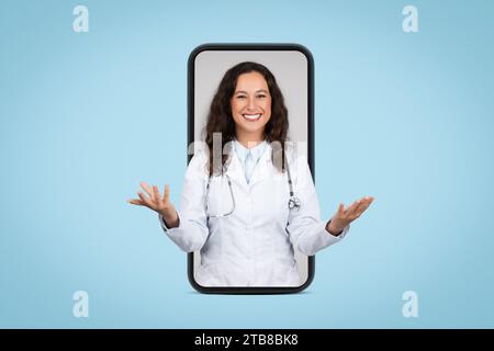 Medical application. Friendly female doctor on big smartphone screen talking to camera consulting patient online Stock Photo