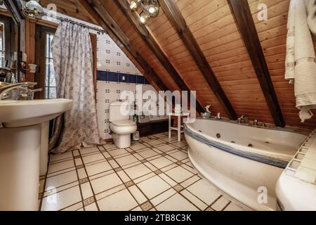 Log cabin bathroom with whirlpool tub Stock Photo