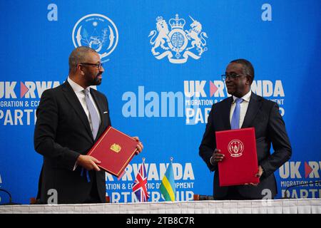 Home Secretary James Cleverly and Rwandan Minister of Foreign Affairs Vincent Biruta sign a new treaty. The treaty will address concerns by the Supreme Court, including assurances that Rwanda will not remove anybody transferred under the partnership to another country. Picture date: Tuesday December 5, 2023. Stock Photo