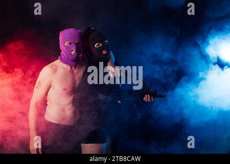 masked terrorists with weapons in the smoke Stock Photo